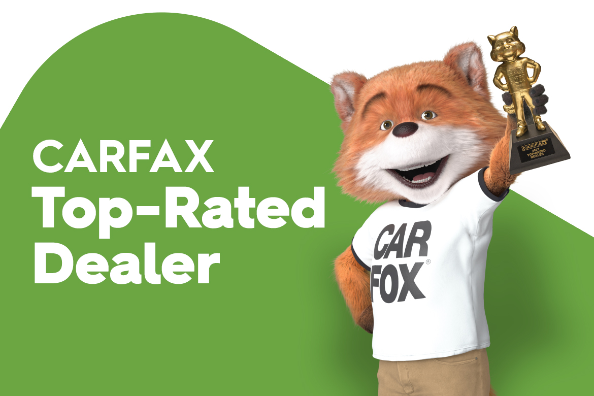 CarFax Fox mascot holding an award for Top Rated Dealer 